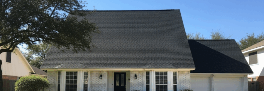 house with a brand-new asphalt shingle roof after a full roof system replacement