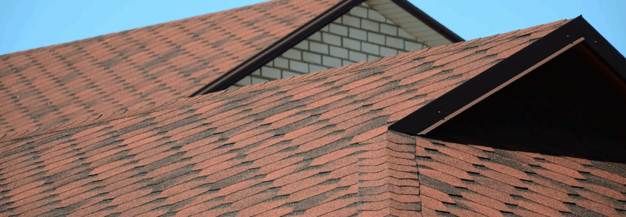 roof with brown bituminous shingles, symbolizing durability and trust in roofing and solar projects