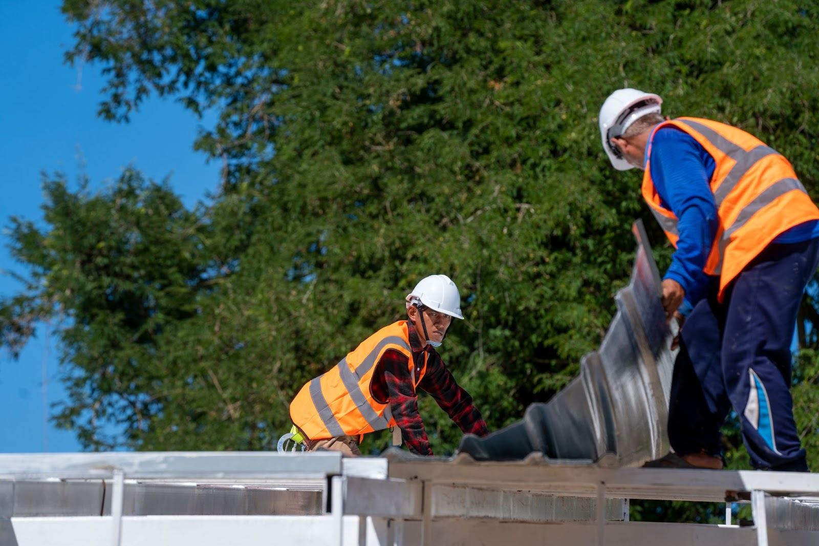 roofing professionals at work, representing importance of roofing and solar contractors