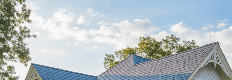 close up of a restored home with fresh roofing and gutters by a roofing contractor DFW TX