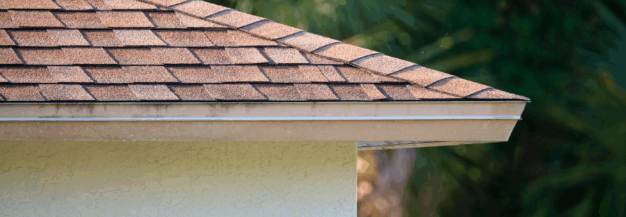 House roof top covered with shingles by a roofing contractor near me