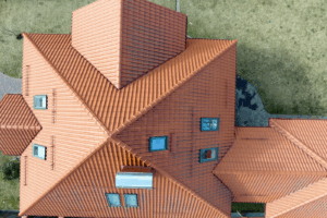 house roof with ceramic shingles, representing the work of roofing and solar contractors