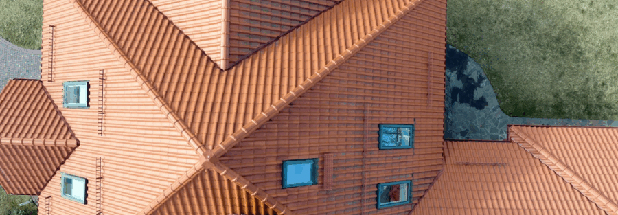 house roof with ceramic shingles, representing the work of roofing and solar contractors