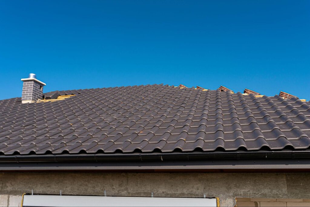 The roof of a single-family house covered with a new ceramic tile in anthracite