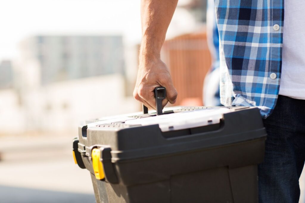 man carrying toolbox