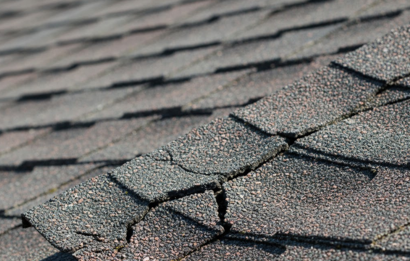 cracked asphalt shingle, underscoring understanding how to repair roof cracks